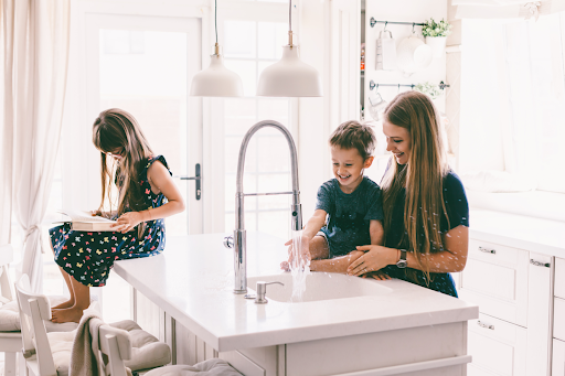A family using a kitchen sink in a Jackson, MS home.