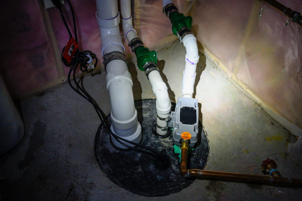 A sump pump installed in a basement.